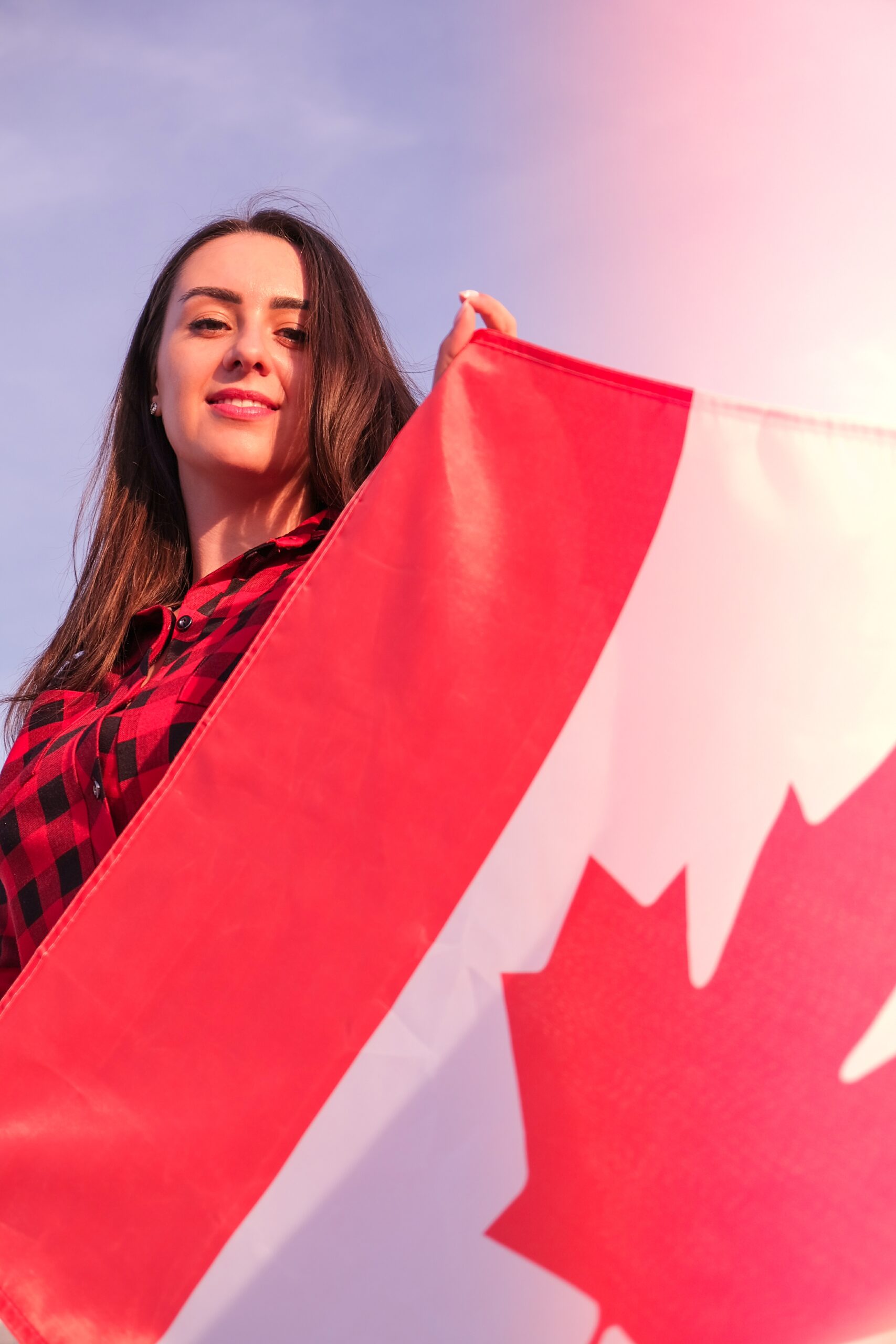 cheerful-young-woman-holds-a-canadian-flag-2026-03-24-05-03-38-utc